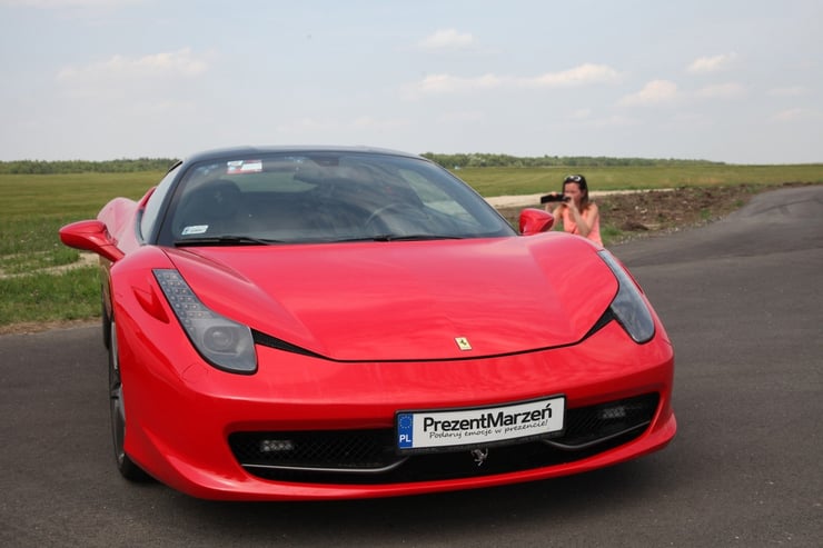 Kobieta fotografująca stojące Ferrari Italia